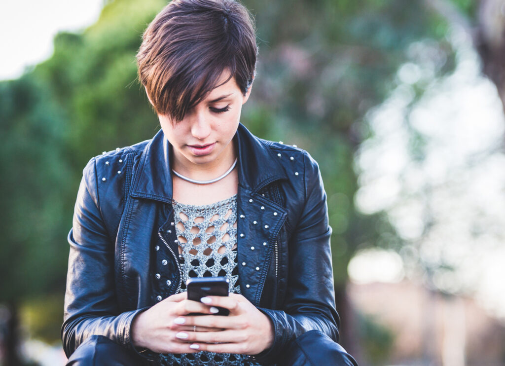 Girl Typing on Mobile Phone