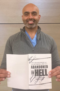 Dr Hussain with book